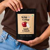 Holding a pouch of Wild & Crisp Apple Crunch