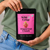 Holding a pouch of Wild & Crisp Dragon Fruit Crunch